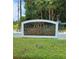 Villas of Stockbridge sign in front of manicured shrubs and trees in a quiet neighborhood at 2922 Burlington Dr, Apopka, FL 32703