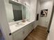 Bathroom features a double sink vanity with sleek white countertops and cabinetry at 312 Irving Bend Dr, Groveland, FL 34736