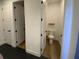 Bathroom boasts a toilet in a separate room and pristine white doors with black handles at 312 Irving Bend Dr, Groveland, FL 34736