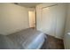 Bedroom features a closet with bi-fold doors and a neutral-toned comforter at 312 Irving Bend Dr, Groveland, FL 34736