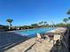 Sparkling community pool with lounge chairs and palm trees, offering a perfect spot for relaxation at 312 Irving Bend Dr, Groveland, FL 34736