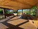 Inviting interior of a wooden gazebo with benches, offering a relaxing space with views of the surrounding landscape at 312 Irving Bend Dr, Groveland, FL 34736
