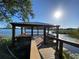 Charming wooden gazebo overlooking a serene lake, providing a peaceful retreat in the community at 312 Irving Bend Dr, Groveland, FL 34736