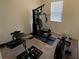 Home gym with various exercise equipment, including a weight machine and rowing machine at 312 Irving Bend Dr, Groveland, FL 34736