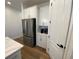 Bright kitchen with stainless steel refrigerator, white cabinets, and a pantry at 312 Irving Bend Dr, Groveland, FL 34736