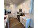 Contemporary kitchen with stainless steel appliances, white cabinets, and quartz countertops at 312 Irving Bend Dr, Groveland, FL 34736