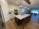 Spacious kitchen features a large island with seating, white cabinets, and stainless steel appliances at 312 Irving Bend Dr, Groveland, FL 34736