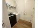 Laundry room with front load washer and dryer on wood-style floors at 312 Irving Bend Dr, Groveland, FL 34736