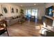 Cozy living room featuring hardwood floors, comfortable seating, and a large window with lots of light at 312 Irving Bend Dr, Groveland, FL 34736