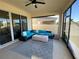 Inviting covered patio with comfortable seating and a ceiling fan for outdoor relaxation at 312 Irving Bend Dr, Groveland, FL 34736