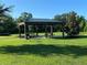 A grassy area featuring an open pavilion with picnic tables offers a place to relax at 312 Irving Bend Dr, Groveland, FL 34736