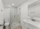 Modern bathroom featuring a glass enclosed shower, new fixtures, and clean white tile at 314 E Harwood St, Orlando, FL 32801