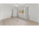 Bright bedroom featuring light wood floors, a ceiling fan, and windows at 314 E Harwood St, Orlando, FL 32801