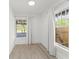 Bright bedroom featuring light wood floors and two windows at 314 E Harwood St, Orlando, FL 32801