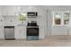 Bright kitchen featuring stainless steel appliances, white cabinets, and subway tile backsplash at 314 E Harwood St, Orlando, FL 32801