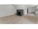 Open-concept living area with decorative fireplace, laminate flooring, and fresh paint at 314 E Harwood St, Orlando, FL 32801