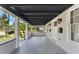 Covered porch with gray tile flooring, stylish lighting, and white craftsman style posts at 314 E Harwood St, Orlando, FL 32801