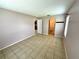 A bedroom featuring neutral walls and tiled flooring that leads to an ensuite bathroom at 337 Live Oak Blvd, Sanford, FL 32773