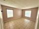 Bedroom with tile flooring, two windows, and neutral wall color at 337 Live Oak Blvd, Sanford, FL 32773
