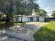 Charming single-story home with an attached garage and a concrete driveway at 337 Live Oak Blvd, Sanford, FL 32773