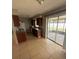 Bright kitchen with access to a screened in patio, featuring tile flooring and a laminate countertops at 337 Live Oak Blvd, Sanford, FL 32773
