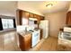 Bright kitchen with wooden cabinets, white appliances, and tile flooring at 337 Live Oak Blvd, Sanford, FL 32773