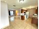 Open-concept kitchen and living area with tile floors and white appliances at 337 Live Oak Blvd, Sanford, FL 32773