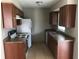 Kitchen with laminate countertops, tile floor and white appliances at 337 Live Oak Blvd, Sanford, FL 32773