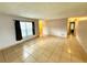 Large living room with neutral walls, tile floors, and natural light through a window at 337 Live Oak Blvd, Sanford, FL 32773