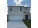 Charming two-story home with a two-car garage, well-manicured lawn, and neutral-colored facade at 3430 Briarwood Grove Dr, Ocoee, FL 34761