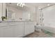Bright bathroom featuring a shower-tub combo, double sinks, and tile flooring at 3600 Plainview Dr, Orlando, FL 32824