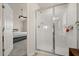 Bathroom featuring tiled walk-in shower and entry to the primary bedroom at 3600 Plainview Dr, Orlando, FL 32824