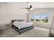 Spacious bedroom with a ceiling fan, large windows, and neutral carpet at 3600 Plainview Dr, Orlando, FL 32824