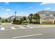 Somerset Crossings community entrance with lush landscaping, trees and well maintained exteriors on a sunny day at 3600 Plainview Dr, Orlando, FL 32824