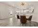 Bright dining area features a stylish chandelier, hardwood floors, and seamless integration to other rooms at 3600 Plainview Dr, Orlando, FL 32824