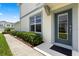 Inviting entryway with a stylish front door, landscaped pathway, and manicured bushes at 3600 Plainview Dr, Orlando, FL 32824
