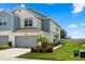 Beautiful townhome with attached garage, complemented by lush landscaping and vibrant greenery at 3600 Plainview Dr, Orlando, FL 32824