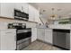 Kitchen showcasing stainless steel appliances and hardware with white countertops and cabinets at 3600 Plainview Dr, Orlando, FL 32824