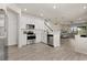 Kitchen featuring stainless steel appliances and white cabinets open to the living area at 3600 Plainview Dr, Orlando, FL 32824