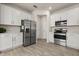 Clean kitchen featuring stainless steel refrigerator, microwave, and oven with white cabinets at 3600 Plainview Dr, Orlando, FL 32824