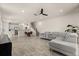 Open-concept living space featuring hardwood floors, a staircase, and seamlessly connected kitchen and dining areas at 3600 Plainview Dr, Orlando, FL 32824