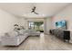 Inviting living room featuring hardwood floors, recessed lighting, stylish furniture, and large sliding doors at 3600 Plainview Dr, Orlando, FL 32824