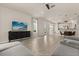 Spacious living area with hardwood floors, a modern entertainment center, and a comfortable couch at 3600 Plainview Dr, Orlando, FL 32824