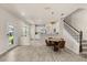 Open floor plan featuring a kitchen, dining area, staircase, and an adjacent entryway at 3600 Plainview Dr, Orlando, FL 32824