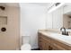 Modern bathroom features walk-in shower with stone accents, vanity and cabinet storage, and black hardware at 407 Ventura Dr, Sanford, FL 32773