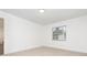 Bright bedroom with neutral carpet, natural light from the window, and fresh white walls at 407 Ventura Dr, Sanford, FL 32773