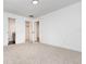 Open bedroom features neutral carpet and white walls, plus access to an attached bathroom and walk-in closet at 407 Ventura Dr, Sanford, FL 32773