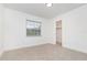 Bright bedroom featuring neutral carpet, natural light from the window, and fresh white walls at 407 Ventura Dr, Sanford, FL 32773