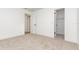 Open bedroom features neutral carpet and white walls, plus access to attached bathroom and a walk-in closet at 407 Ventura Dr, Sanford, FL 32773