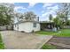 Exterior view of the home showcasing the backyard, screened porch, and patio at 407 Ventura Dr, Sanford, FL 32773
